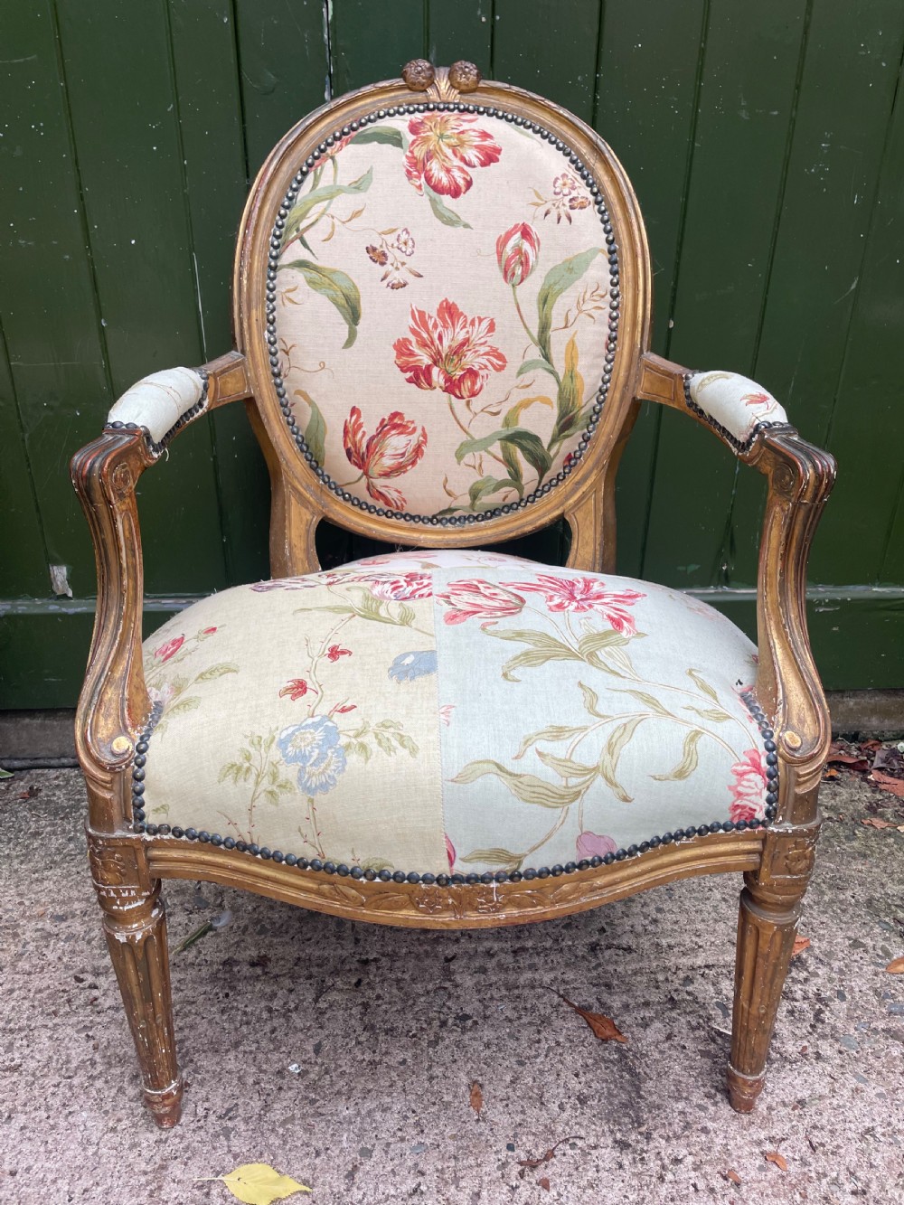 A pair of mid-19th-century French Louis XVI style giltwood salon armchairs with oval backs and floral upholstery. View IX