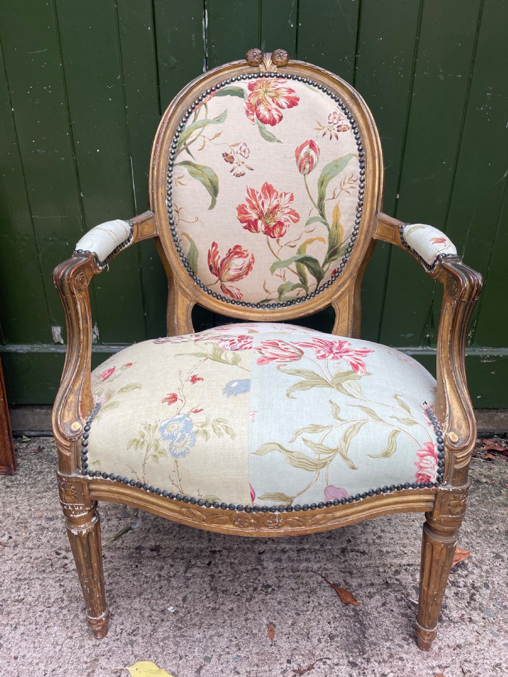 A pair of mid-19th-century French Louis XVI style giltwood salon armchairs with oval backs and floral upholstery. View XII