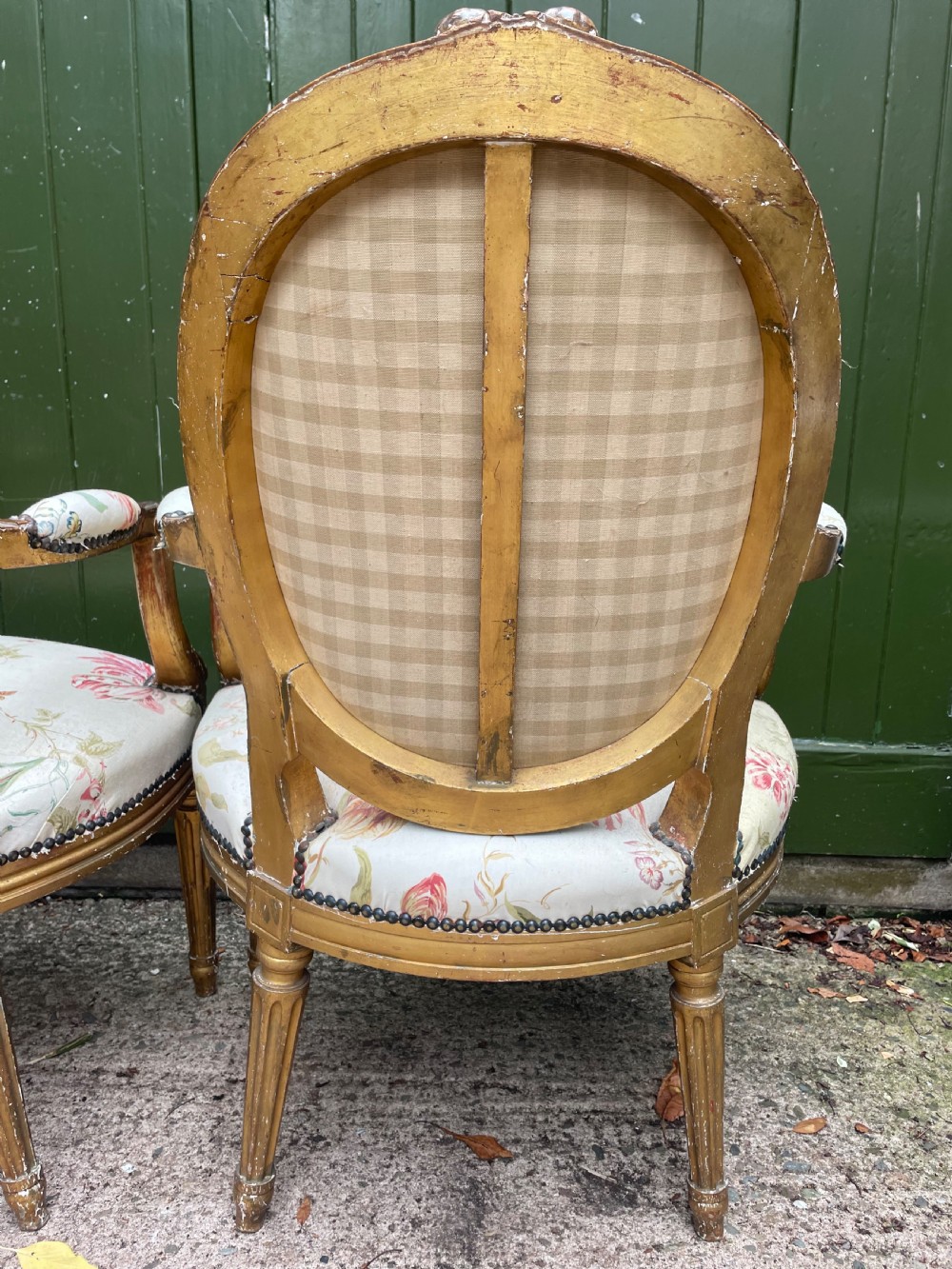 A pair of mid-19th-century French Louis XVI style giltwood salon armchairs with oval backs and floral upholstery. View XV