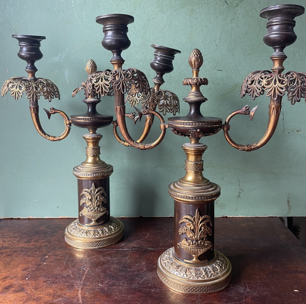 Pair of early C19th Regency period patinated bronze and ormolu twin-branch candelabras.