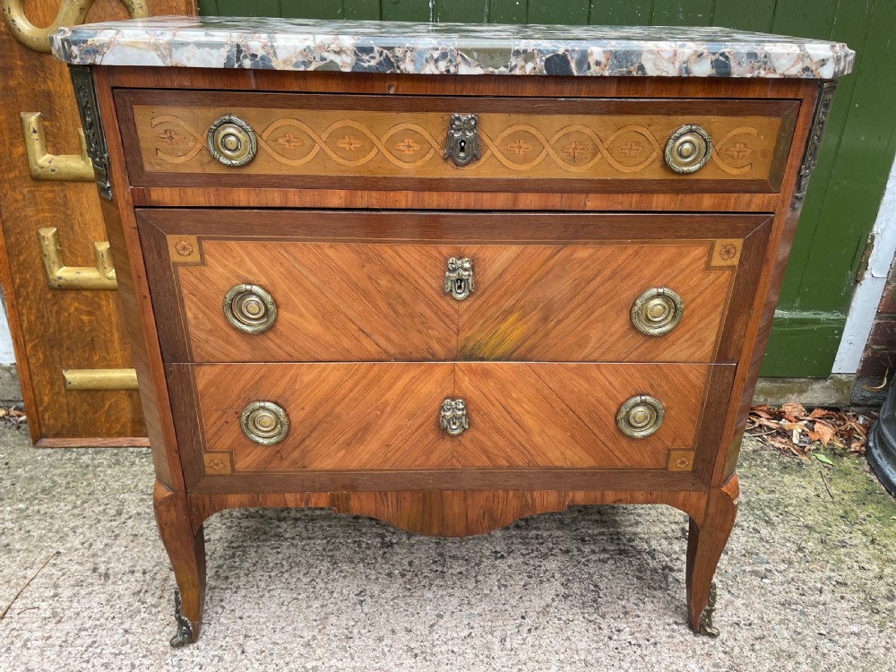 A late nineteenth-century French Louis XVI transitional style commode featuring marquetry wood veneers, brass ring handles, and a grey marble top. View III
