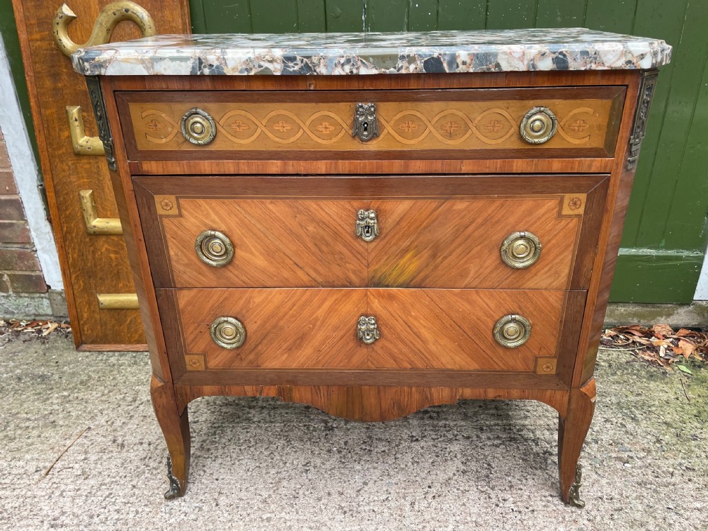A late nineteenth-century French Louis XVI transitional style commode featuring marquetry wood veneers, brass ring handles, and a grey marble top. View XI