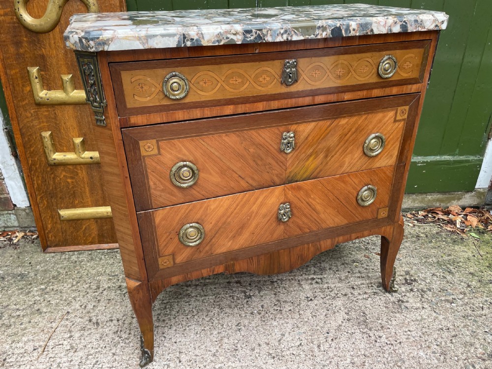A late nineteenth-century French Louis XVI transitional style commode featuring marquetry wood veneers, brass ring handles, and a grey marble top. View XXIII