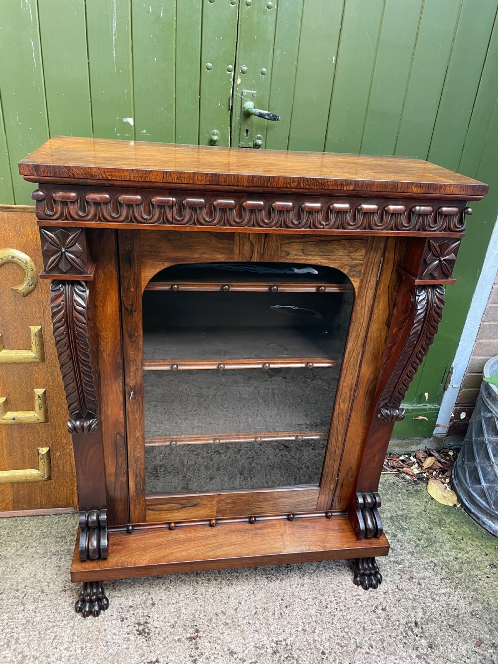 Early C19th George IV period carved rosewood glazed bookcase or pier cabinet of bold design .  View IV