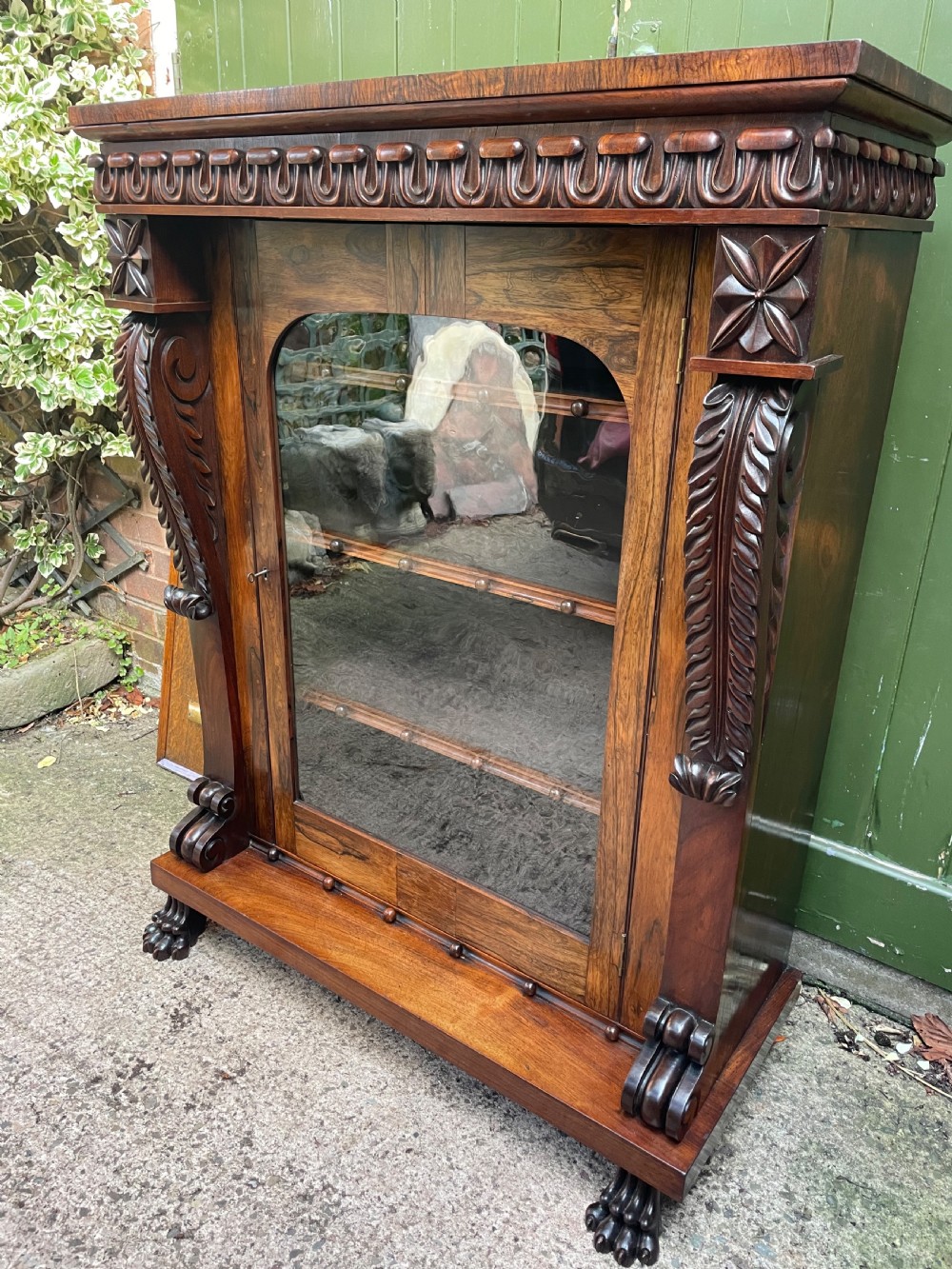 Early C19th George IV period carved rosewood glazed bookcase or pier cabinet of bold design .  View V