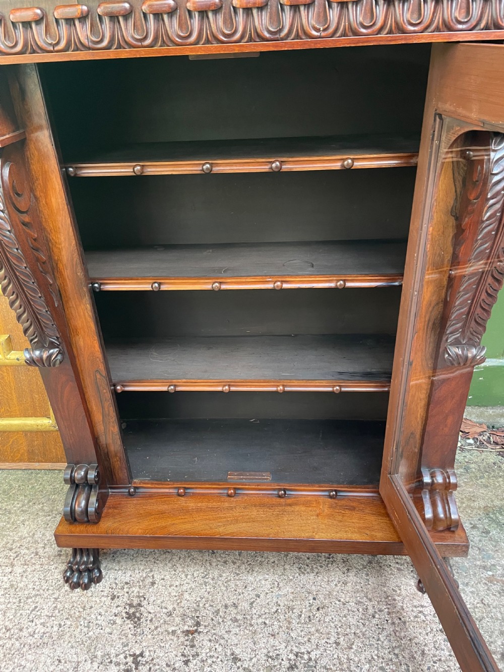 Early C19th George IV period carved rosewood glazed bookcase or pier cabinet of bold design .  View IX