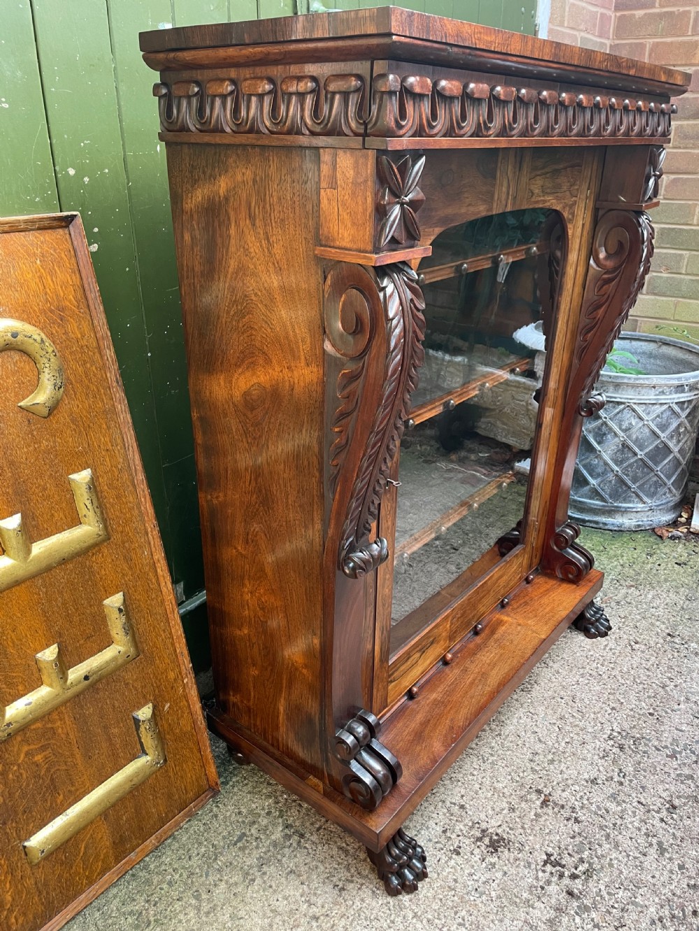 Early C19th George IV period carved rosewood glazed bookcase or pier cabinet of bold design .  View X