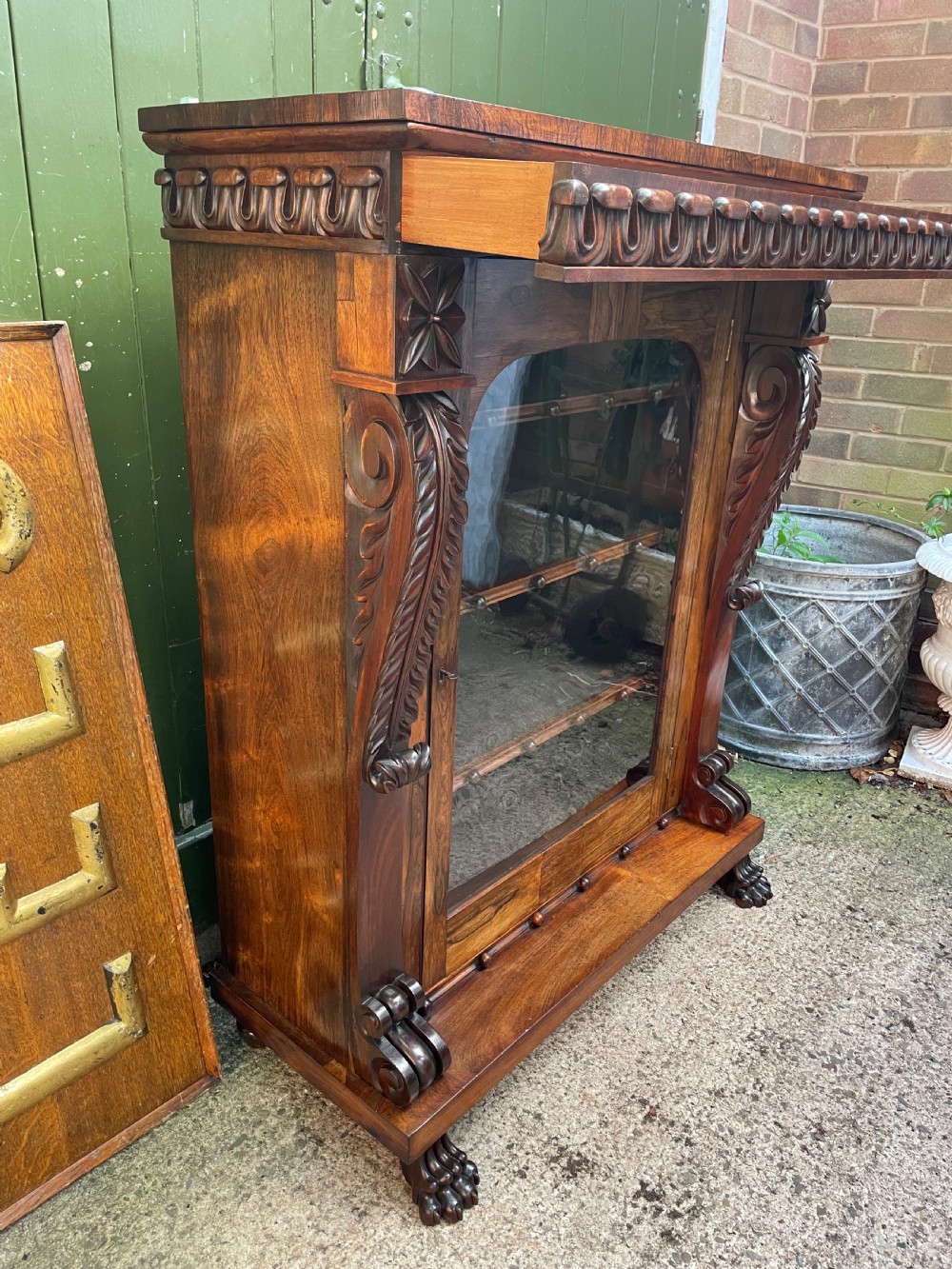 Early C19th George IV period carved rosewood glazed bookcase or pier cabinet of bold design .  View XI