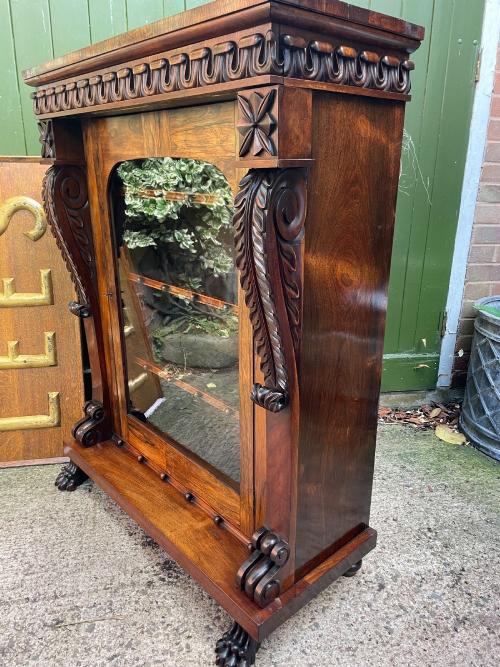 Early C19th George IV period carved rosewood glazed bookcase or pier cabinet of bold design .  View XII