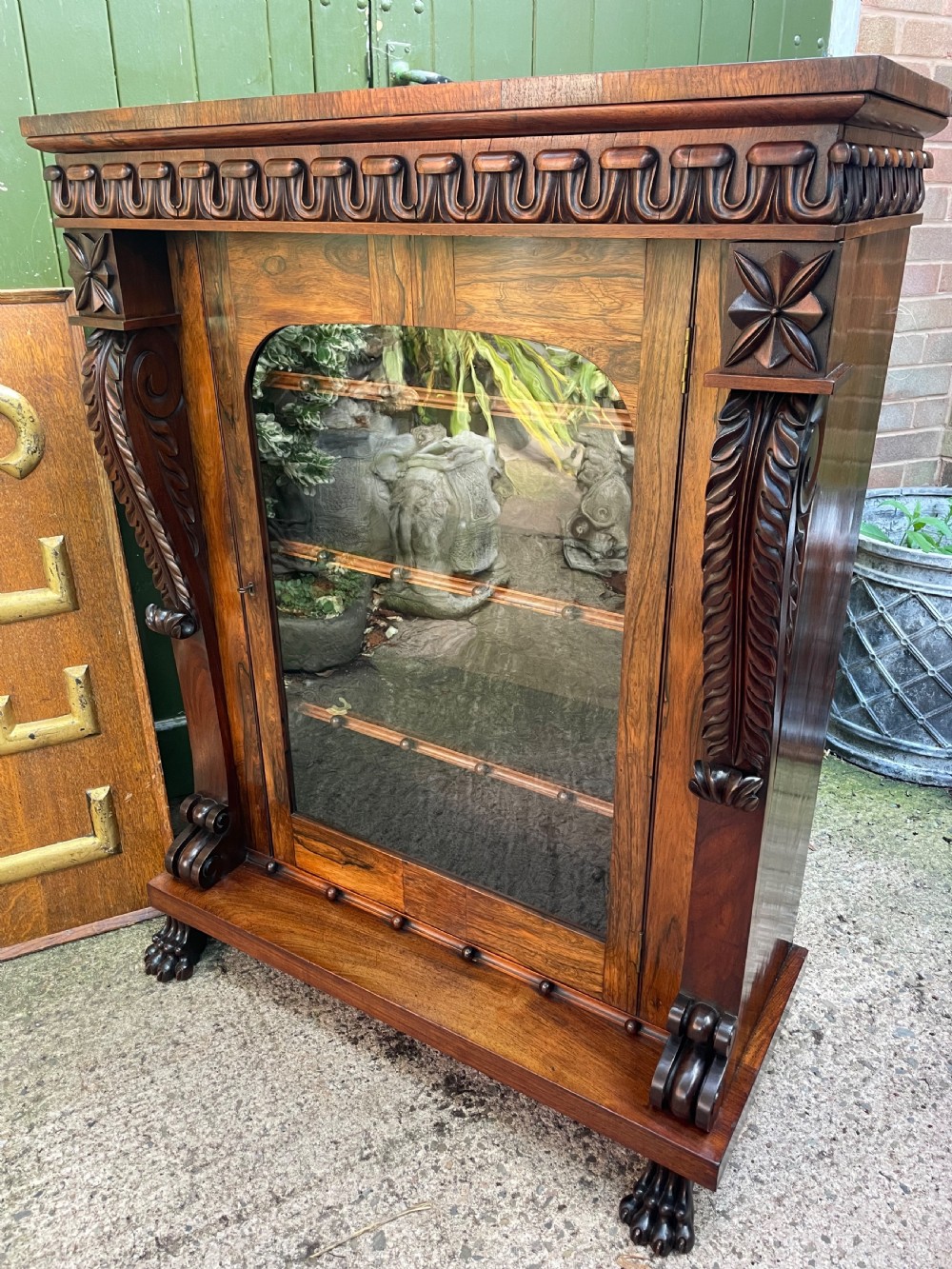 Early C19th George IV period carved rosewood glazed bookcase or pier cabinet of bold design .  View XIII