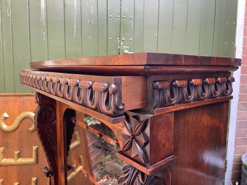 Early C19th George IV period carved rosewood glazed bookcase or pier cabinet of bold design .  View XIV