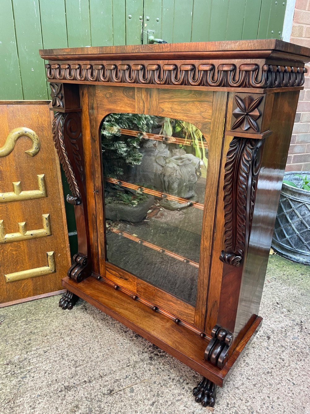 Early C19th George IV period carved rosewood glazed bookcase or pier cabinet of bold design .  View XVI