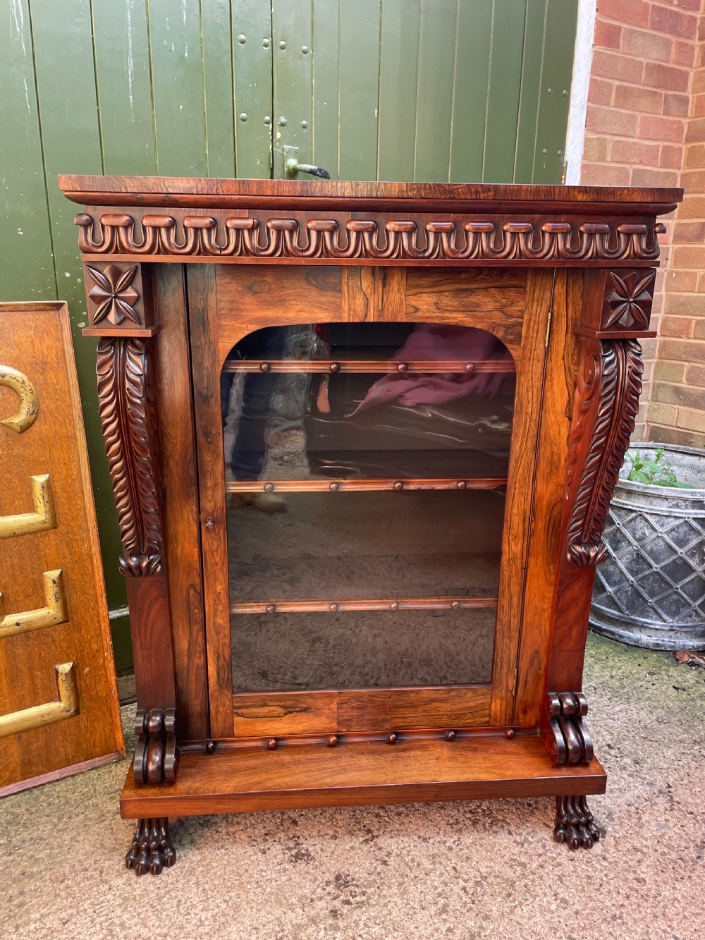 Early C19th George IV period carved rosewood glazed bookcase or pier cabinet of bold design .  View XXI