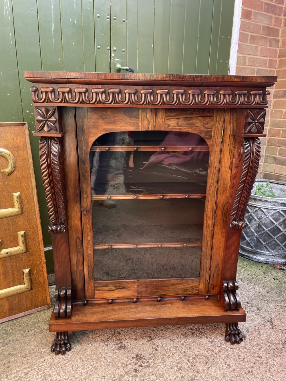 Early C19th George IV period carved rosewood glazed bookcase or pier cabinet of bold design .  View XXVI