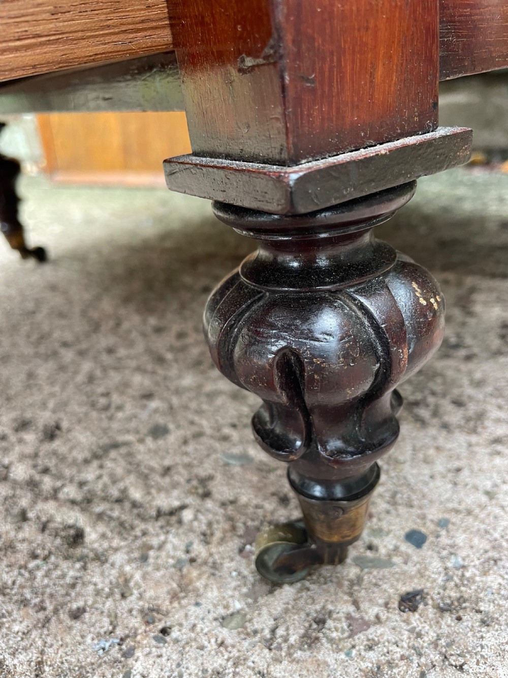 An early nineteenth-century George IV mahogany four-tier etagere featuring carved pinecone finials, turned supports, a single lower drawer, and brass castors. View XI