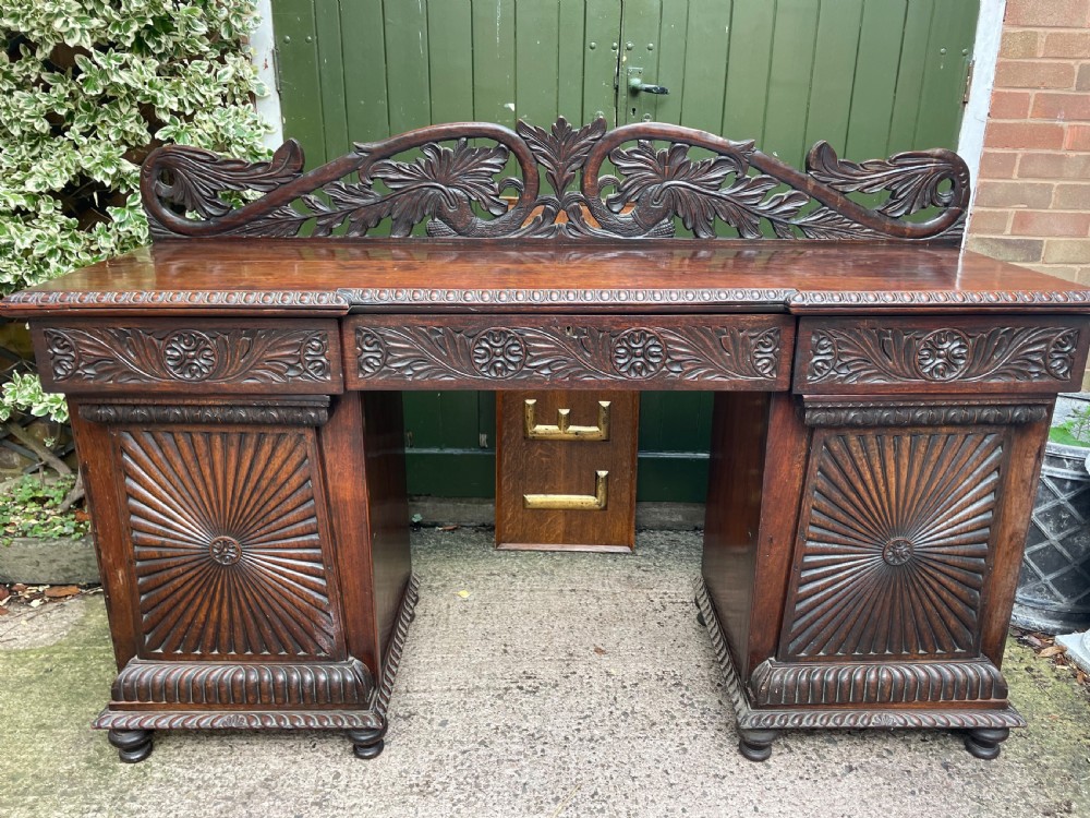 C19th Anglo-Indian carved padauk pedestal sideboard. View II