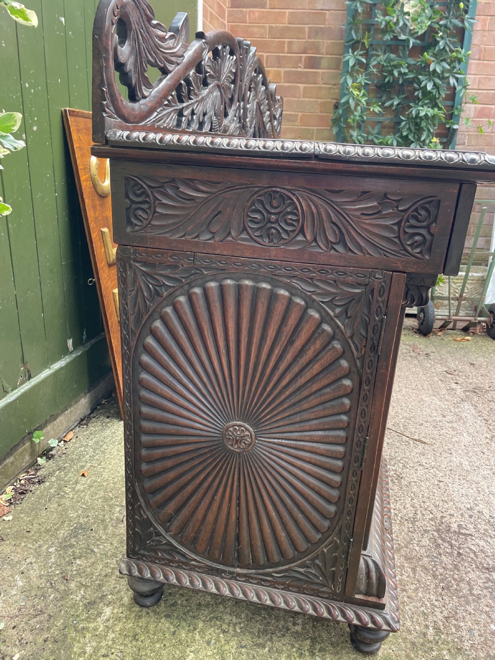 C19th Anglo-Indian carved padauk pedestal sideboard. View III