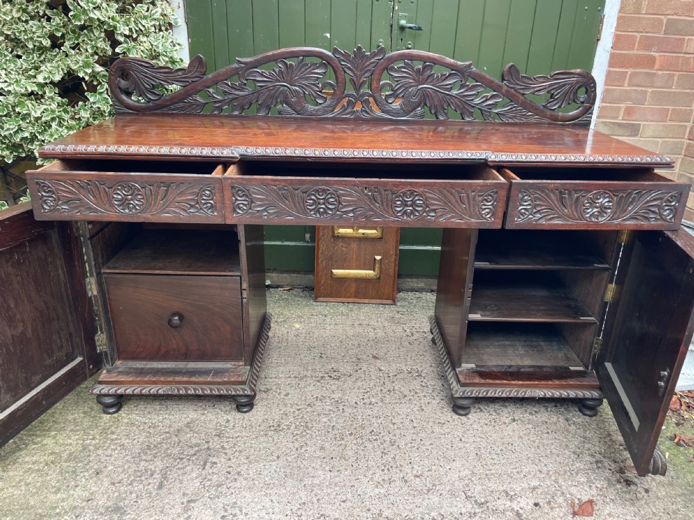 C19th Anglo-Indian carved padauk pedestal sideboard. View VIII