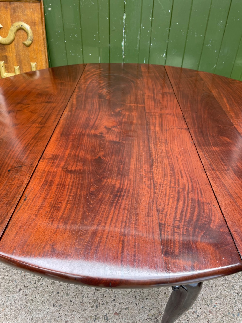 A mid-18th century George II Cuban mahogany drop-leaf table featuring an oval top, cabriole legs, and pad feet. View XIV