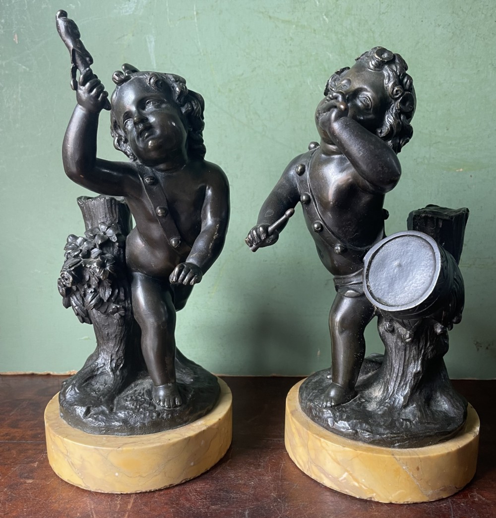 Pair of early C19th French bronze allegorical sculptures of cherubs , emblematic of music and comedy after Clodion.
