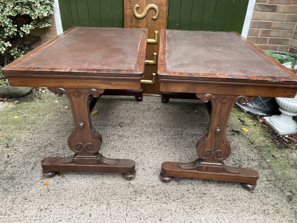 A matching pair of early 19th-century George IV mahogany writing tables featuring inset leather tops, carved trestle legs, and turned stretchers. View XVI