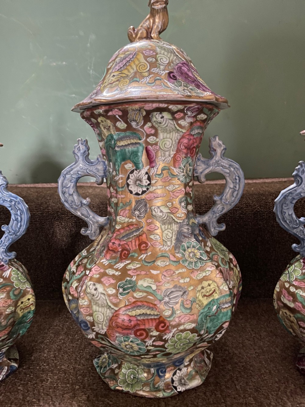 A three-piece nineteenth-century Masons Ironstone garniture set decorated with Chinoiserie enamel patterns, blue handles, and lion lid finials. View VII