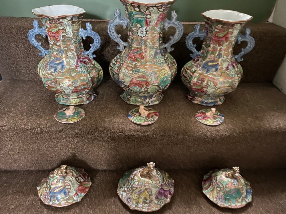 A three-piece nineteenth-century Masons Ironstone garniture set decorated with Chinoiserie enamel patterns, blue handles, and lion lid finials. View VIII