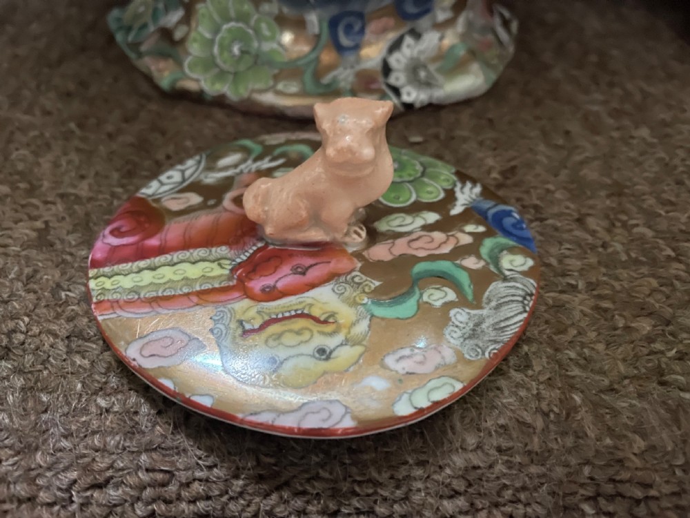 A three-piece nineteenth-century Masons Ironstone garniture set decorated with Chinoiserie enamel patterns, blue handles, and lion lid finials. View XI