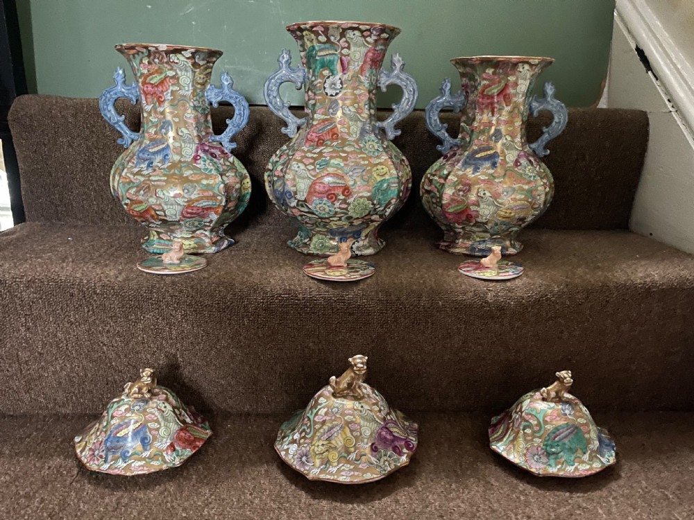 A three-piece nineteenth-century Masons Ironstone garniture set decorated with Chinoiserie enamel patterns, blue handles, and lion lid finials. View XII