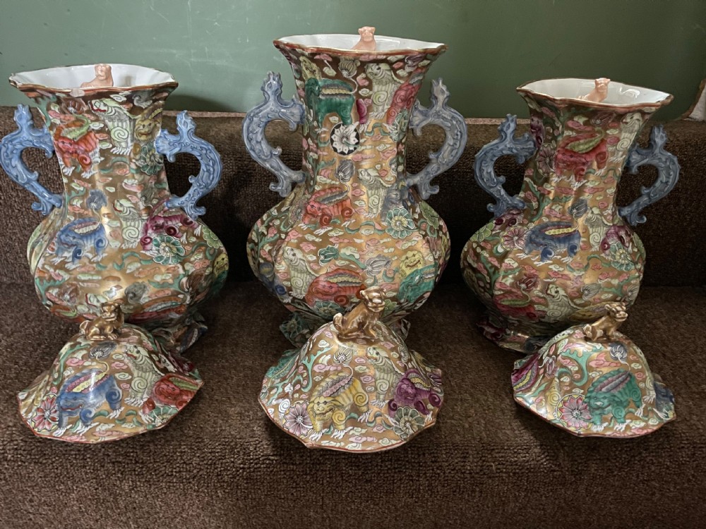 A three-piece nineteenth-century Masons Ironstone garniture set decorated with Chinoiserie enamel patterns, blue handles, and lion lid finials. View XIV