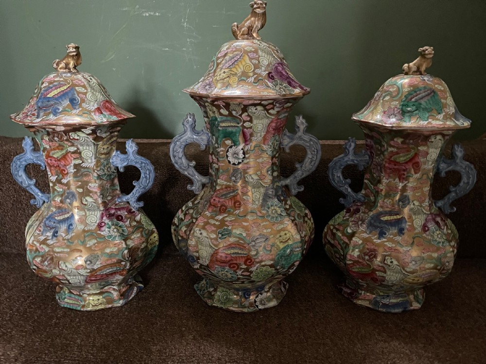 A three-piece nineteenth-century Masons Ironstone garniture set decorated with Chinoiserie enamel patterns, blue handles, and lion lid finials. View XV