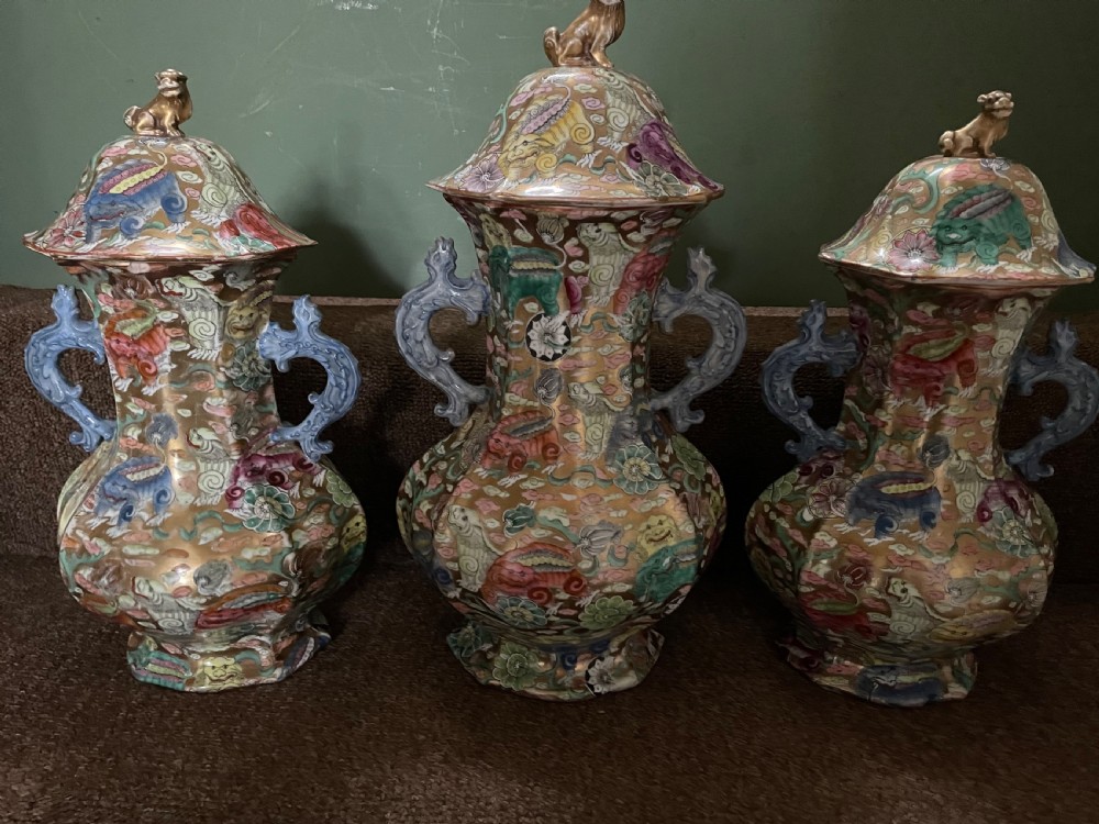 A three-piece nineteenth-century Masons Ironstone garniture set decorated with Chinoiserie enamel patterns, blue handles, and lion lid finials. View XVI
