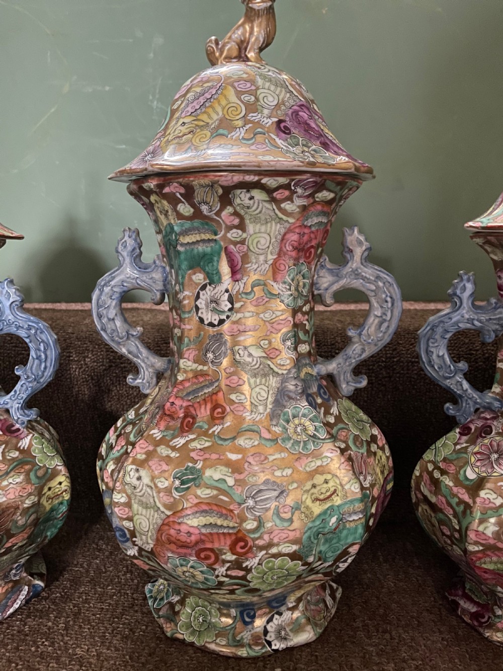 A three-piece nineteenth-century Masons Ironstone garniture set decorated with Chinoiserie enamel patterns, blue handles, and lion lid finials. View XX