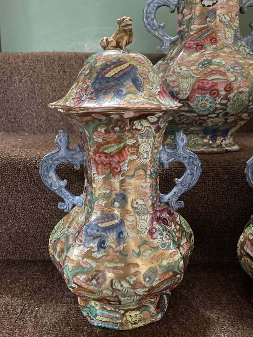 A three-piece nineteenth-century Masons Ironstone garniture set decorated with Chinoiserie enamel patterns, blue handles, and lion lid finials. View XXII