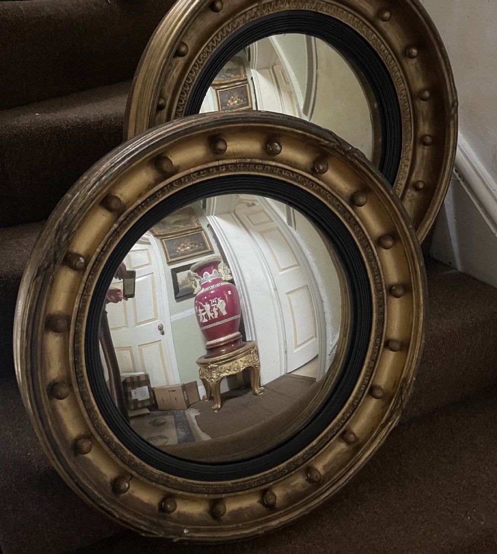 Matched pair of early C19th Regency period circular gilt-wood framed convex-plate mirrors  View II