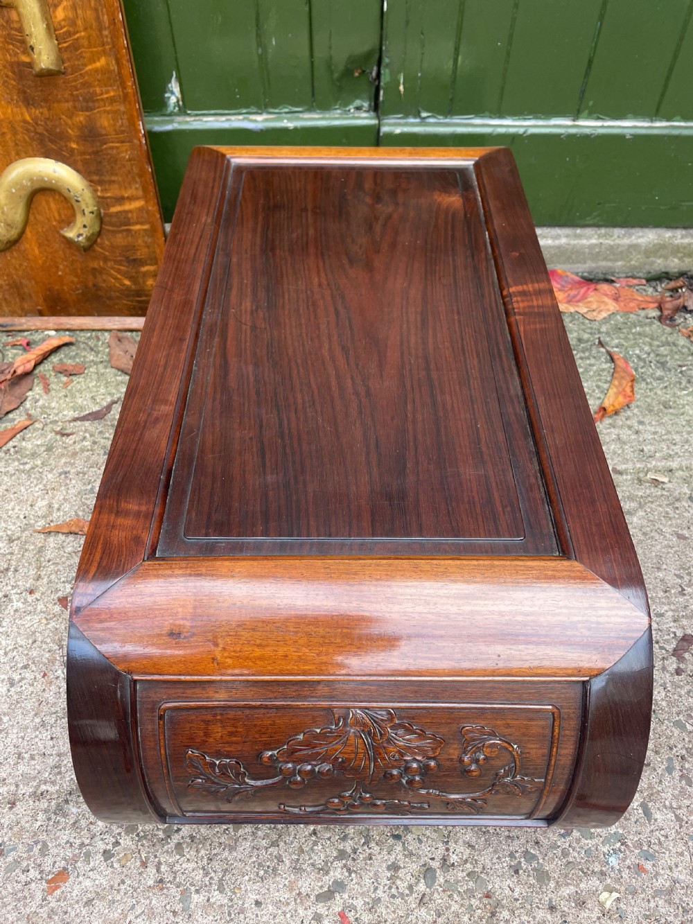 A low Chinese huali wood kang table featuring an openwork carved apron and scroll-end legs. View IX
