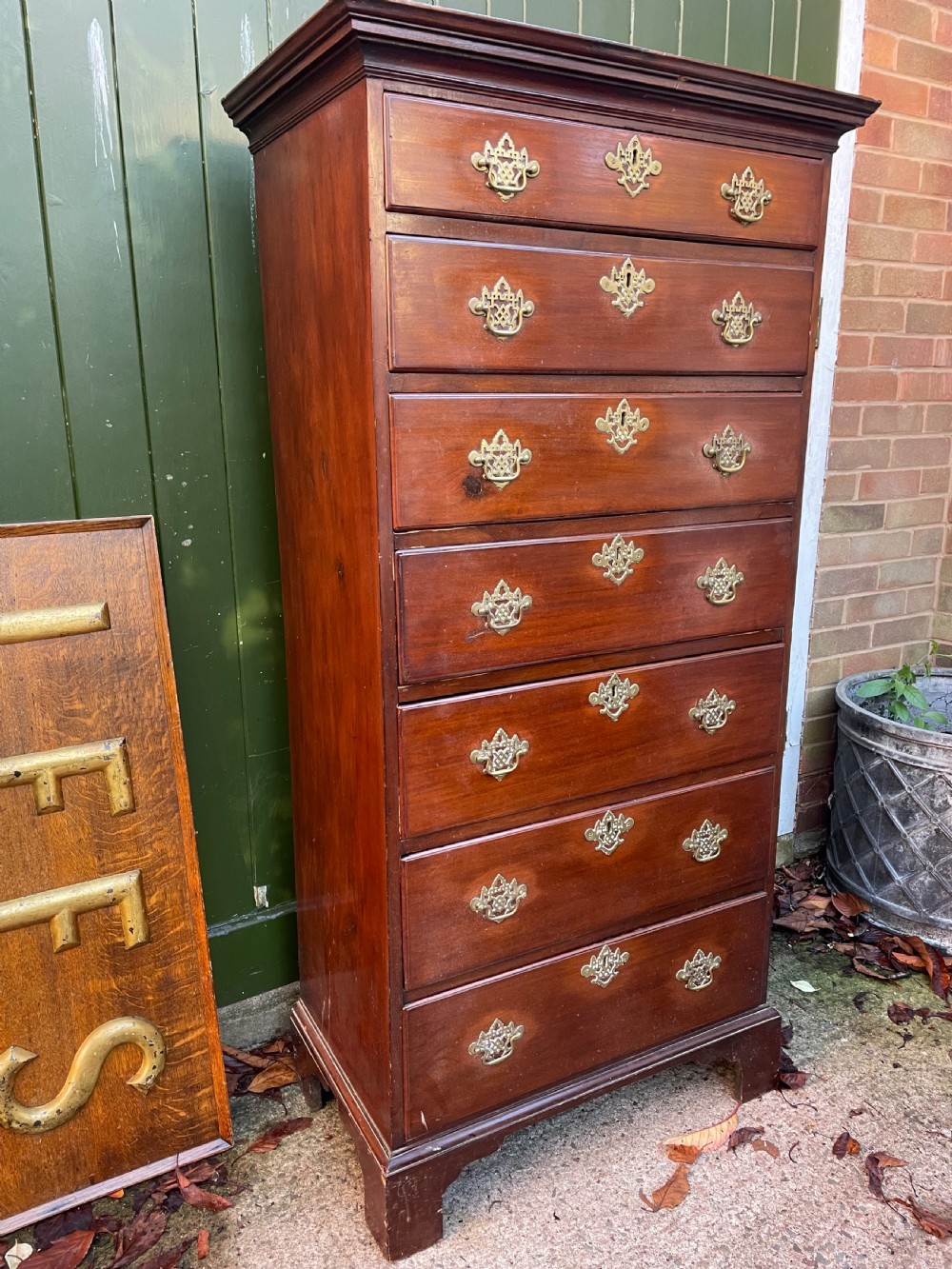 A mid-18th-century George III mahogany tallboy chest comprising seven graduated drawers with decorative pierced brass handles and bracket feet. View VII