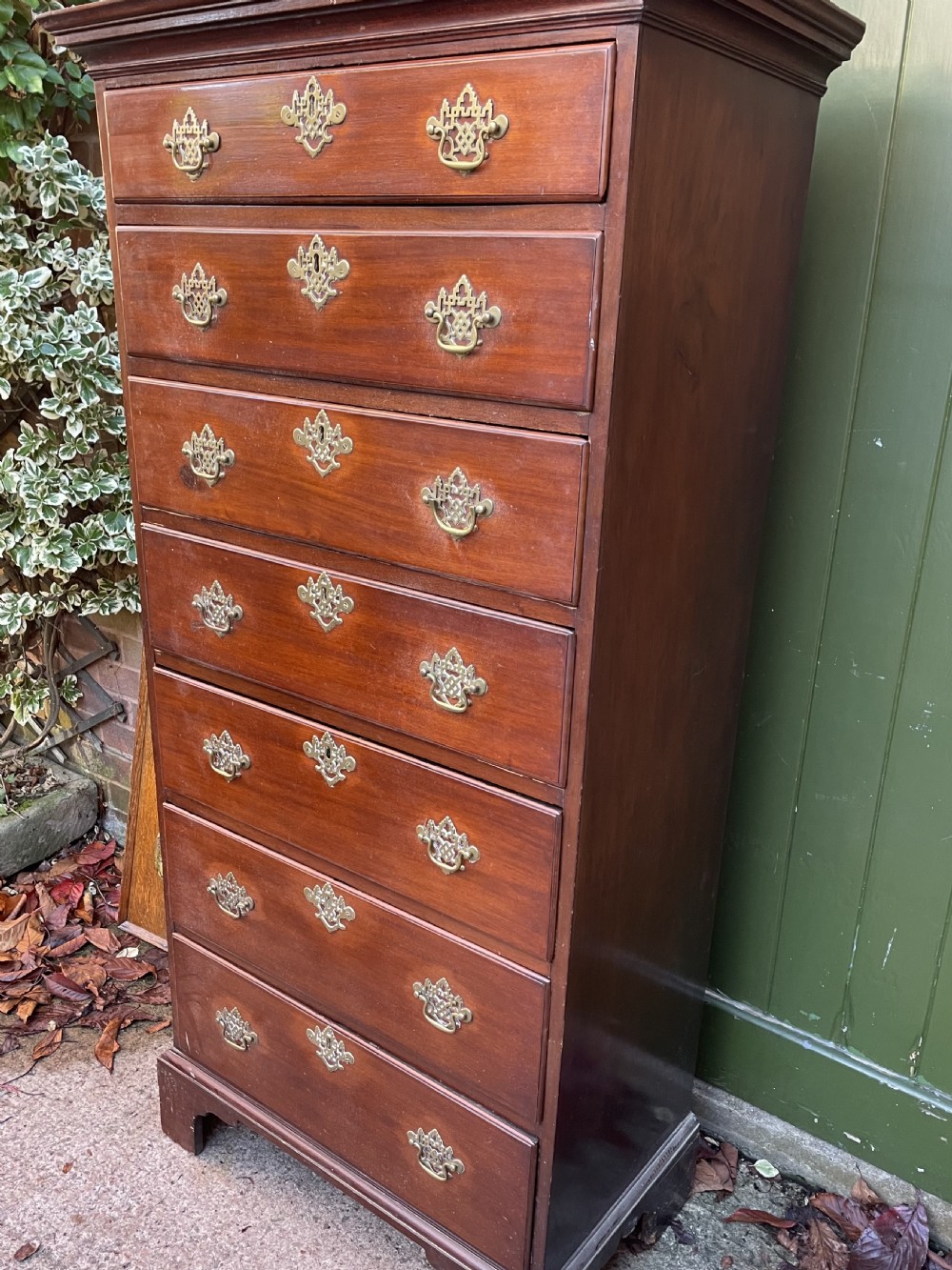 A mid-18th-century George III mahogany tallboy chest comprising seven graduated drawers with decorative pierced brass handles and bracket feet. View VIII