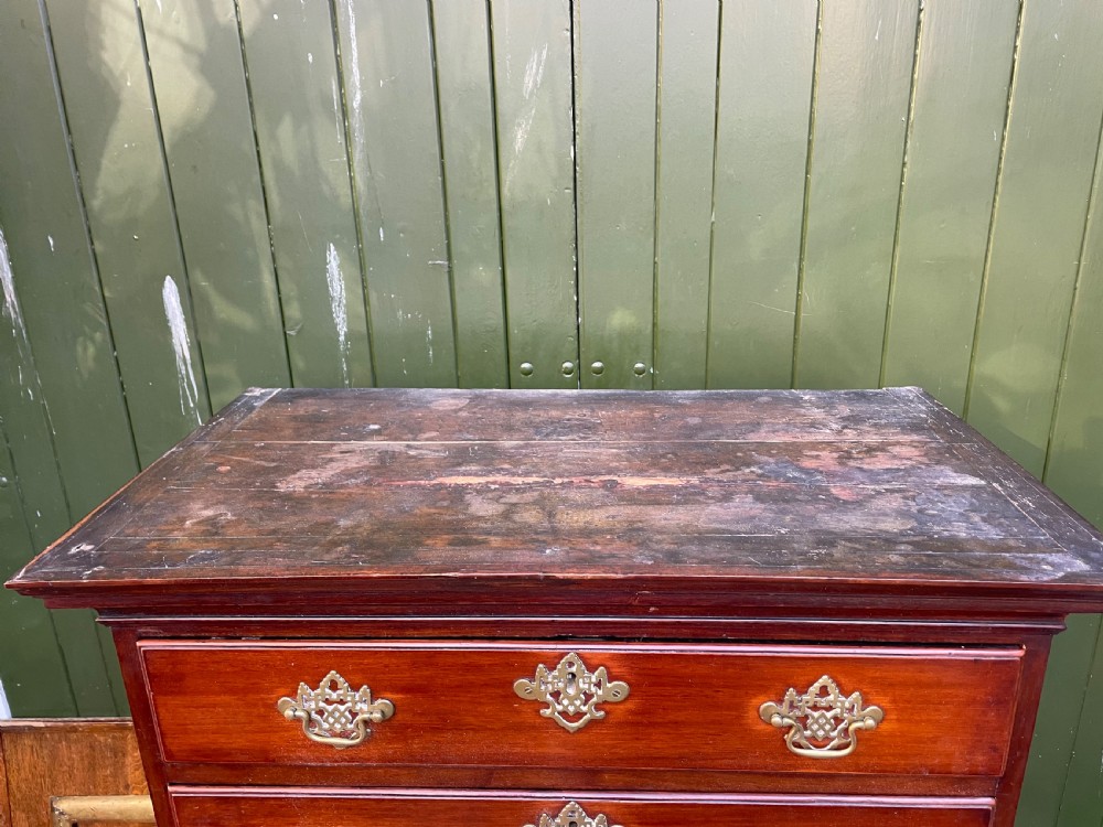 A mid-18th-century George III mahogany tallboy chest comprising seven graduated drawers with decorative pierced brass handles and bracket feet. View X
