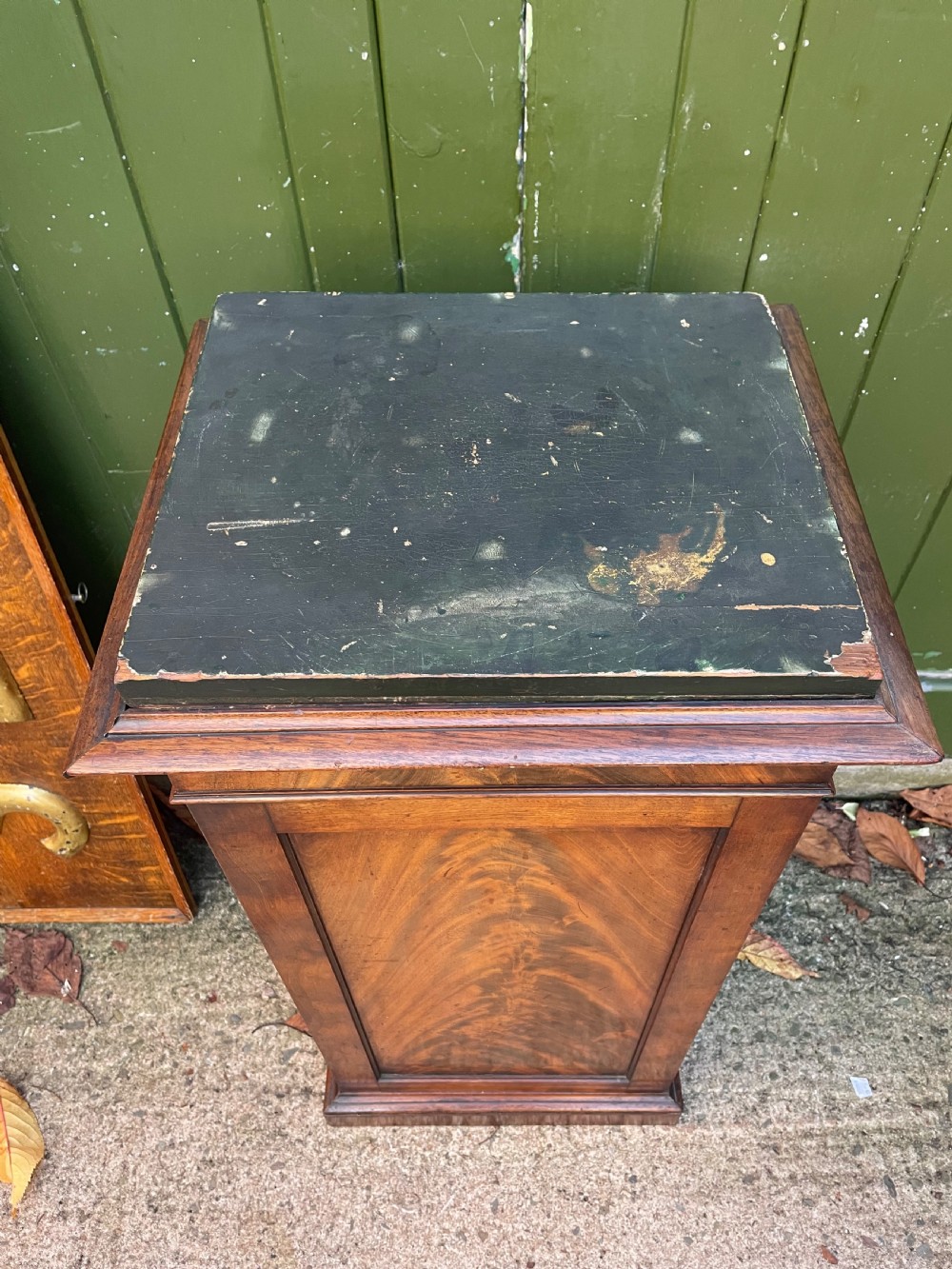 An early nineteenth-century Georgian mahogany pedestal cupboard featuring a flame mahogany veneered front panel, moulded top cornice, and plinth base. View II