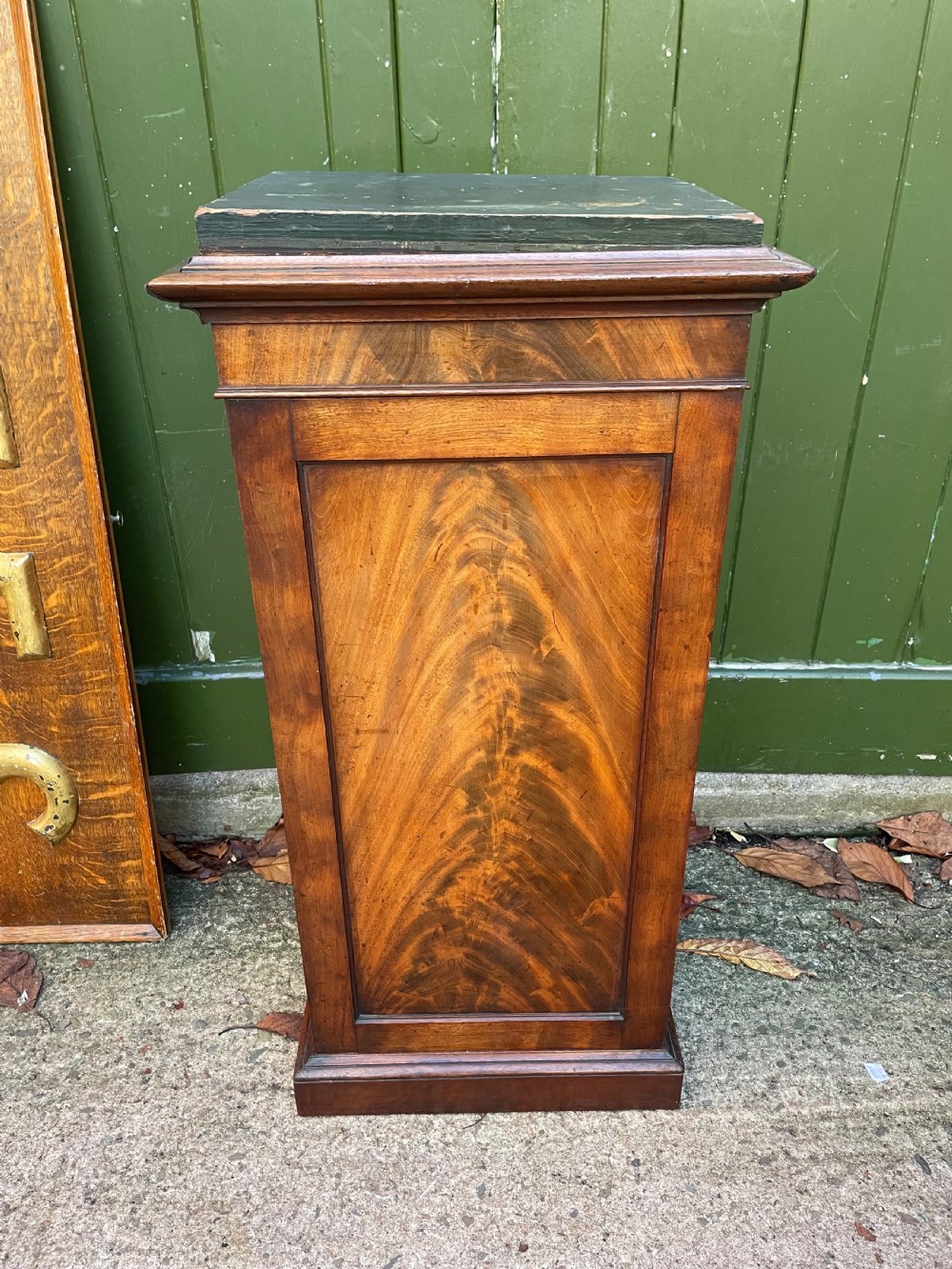 An early nineteenth-century Georgian mahogany pedestal cupboard featuring a flame mahogany veneered front panel, moulded top cornice, and plinth base. View VII