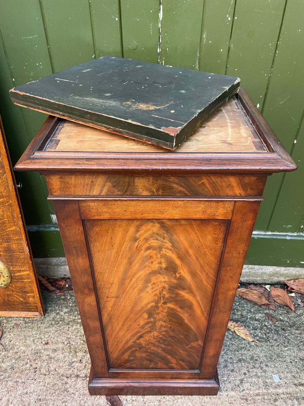 An early nineteenth-century Georgian mahogany pedestal cupboard featuring a flame mahogany veneered front panel, moulded top cornice, and plinth base. View VIII