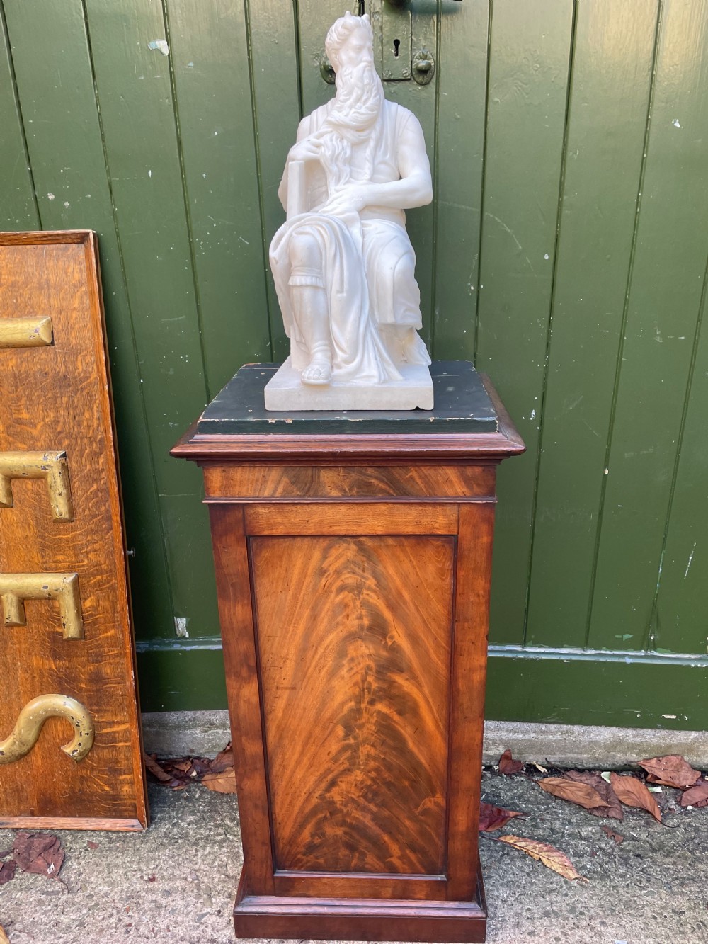An early nineteenth-century Georgian mahogany pedestal cupboard featuring a flame mahogany veneered front panel, moulded top cornice, and plinth base. View XI