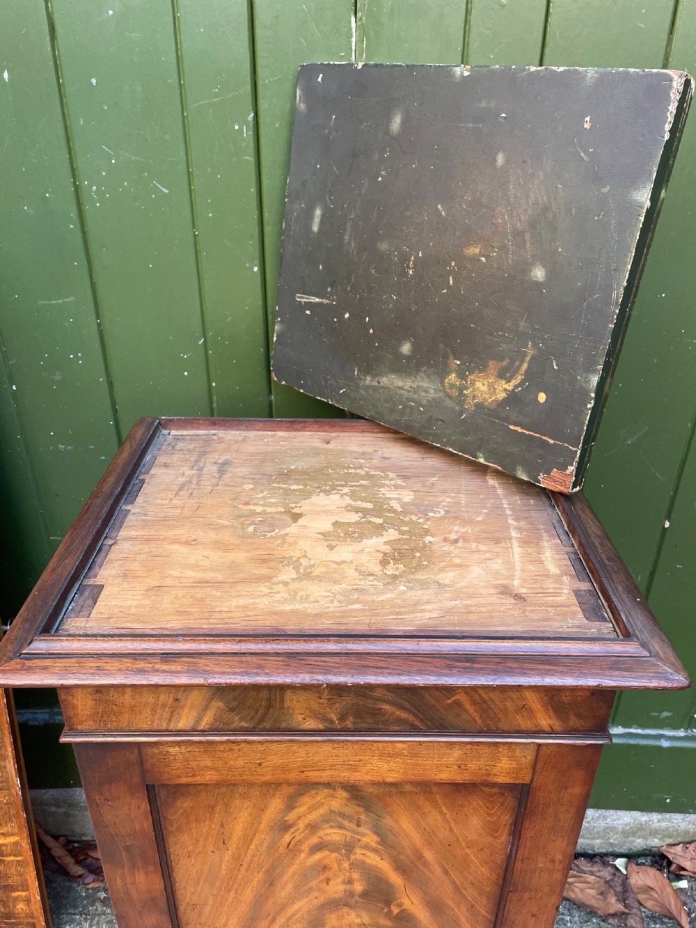 An early nineteenth-century Georgian mahogany pedestal cupboard featuring a flame mahogany veneered front panel, moulded top cornice, and plinth base. View XIV