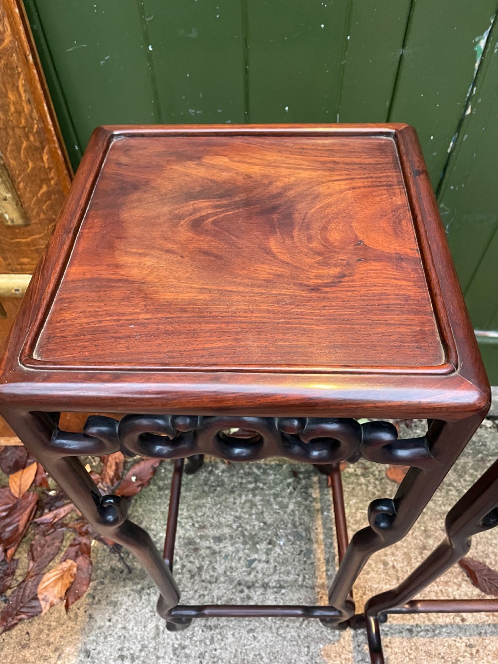 A pair of tall late 19th-century Chinese Qing Dynasty dark hardwood stands featuring square tops, openwork carved scroll aprons, and slender serpentine legs. View VIII