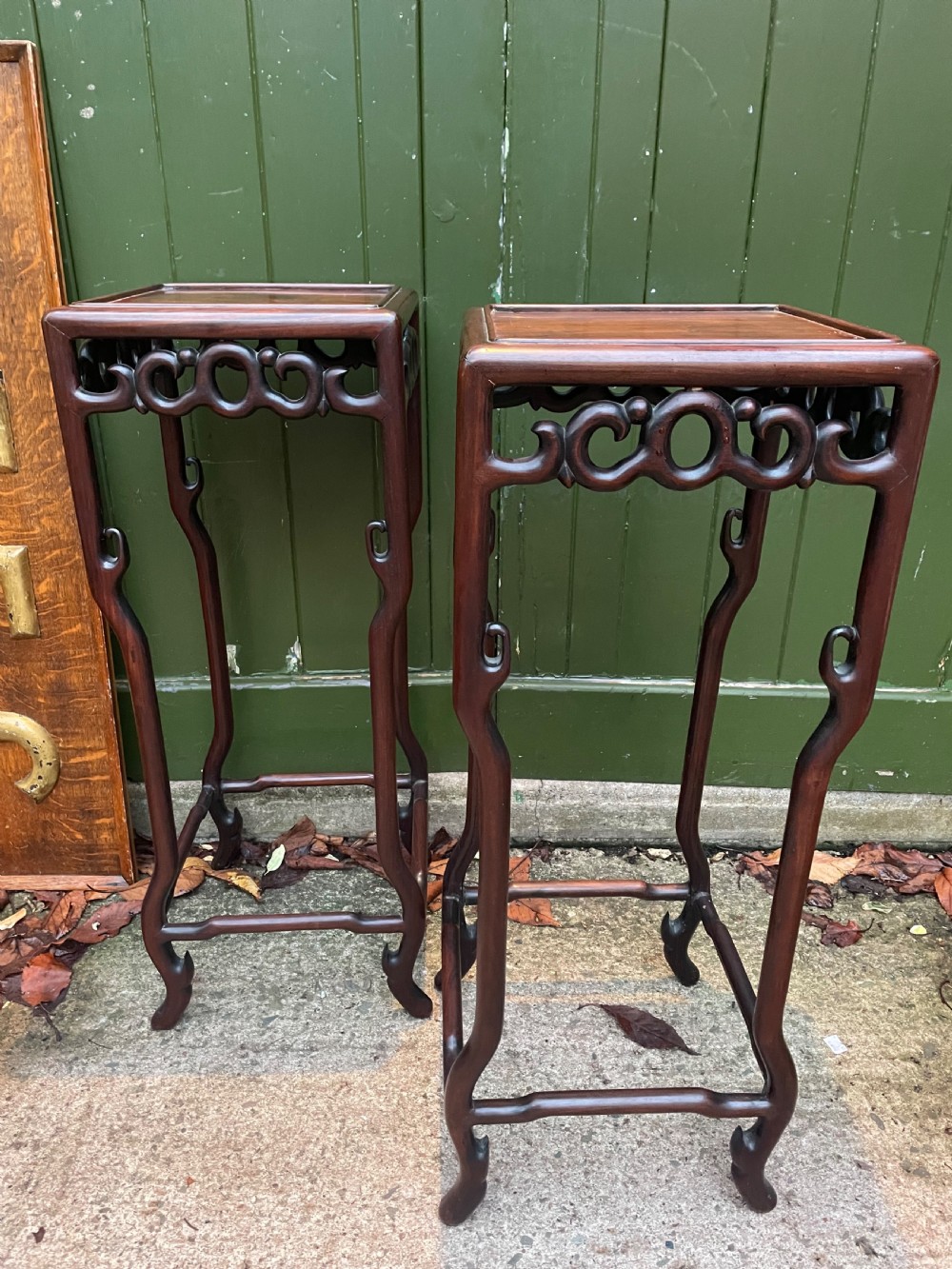 A pair of tall late 19th-century Chinese Qing Dynasty dark hardwood stands featuring square tops, openwork carved scroll aprons, and slender serpentine legs. View XIII