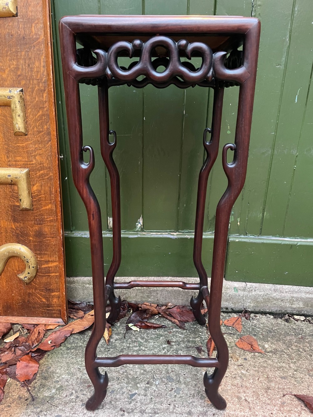 A pair of tall late 19th-century Chinese Qing Dynasty dark hardwood stands featuring square tops, openwork carved scroll aprons, and slender serpentine legs. View XVI
