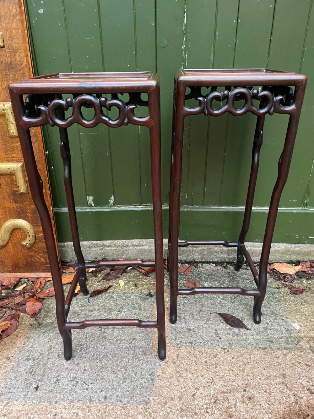 A pair of tall late 19th-century Chinese Qing Dynasty dark hardwood stands featuring square tops, openwork carved scroll aprons, and slender serpentine legs. View XXI