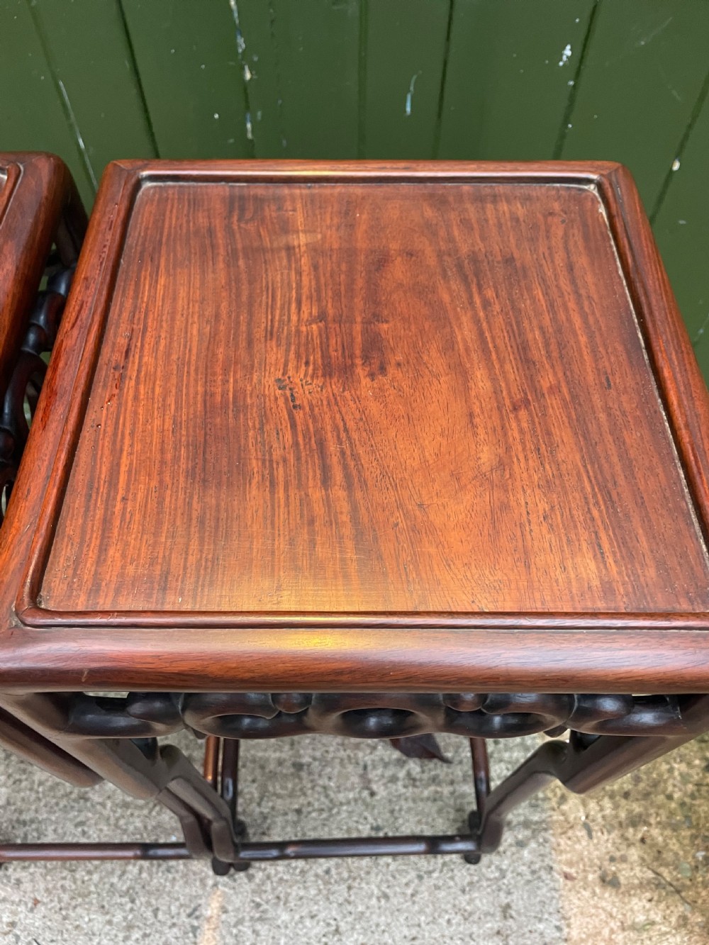 A pair of tall late 19th-century Chinese Qing Dynasty dark hardwood stands featuring square tops, openwork carved scroll aprons, and slender serpentine legs. View XXIV