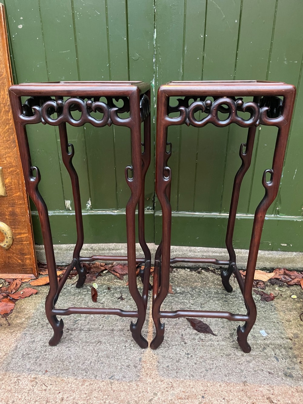 A pair of tall late 19th-century Chinese Qing Dynasty dark hardwood stands featuring square tops, openwork carved scroll aprons, and slender serpentine legs. View XXV